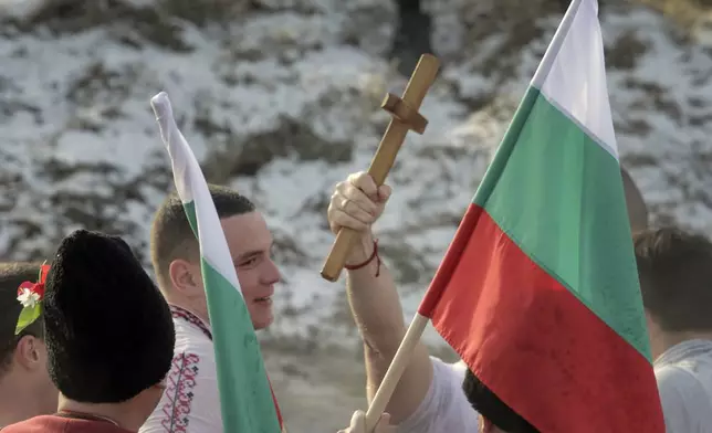 Bulgarians hold a wooden cross in the Lesnovska River during Epiphany Day celebrations in the town of Elin Pelin, Bulgaria, Monday, Jan. 6, 2025. (AP Photo/Valentina Petrova)