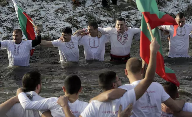 Bulgarians sing and dance in the Lesnovska River during Epiphany Day celebrations in the town of Elin Pelin, Bulgaria, Monday, Jan. 6, 2025. (AP Photo/Valentina Petrova)