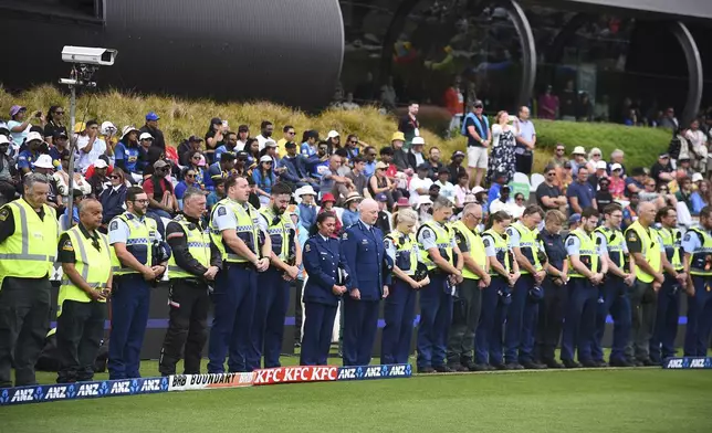 Members of the New Zealand Police stand for a moment of silence for fallen officer Lyn Fleming during the 3rd T20 match between New Zealand and Sri Lanka at Saxton Oval in Nelson, New Zealand, Thursday, Jan. 2, 2025. (Chris Symes/Photosport via AP)