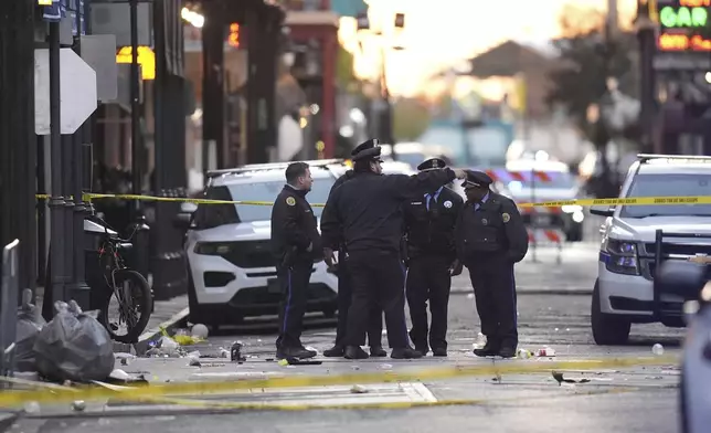 Emergency services attend the scene on Bourbon Street after a vehicle drove into a crowd on New Orleans' Canal and Bourbon Street, Wednesday Jan. 1, 2025. (AP Photo/Gerald Herbert)