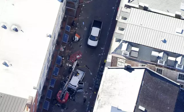 Investigators work the scene after a person drove a vehicle into a crowd earlier on Canal and Bourbon Street in New Orleans, Wednesday, Jan. 1, 2025. (AP Photo/Gerald Herbert)