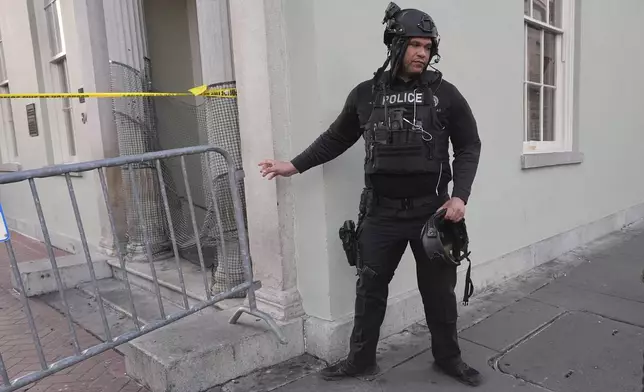 A member of the emergency services attends the scene after a vehicle drove into a crowd on New Orleans' Canal and Bourbon Street, Wednesday Jan. 1, 2025. (AP Photo/Gerald Herbert)