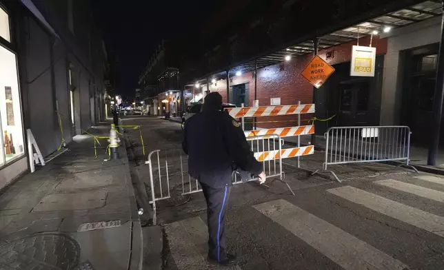 Emergency services attend the scene after a vehicle drove into a crowd on New Orleans' Canal and Bourbon Street, Wednesday Jan. 1, 2025. (AP Photo/Gerald Herbert)