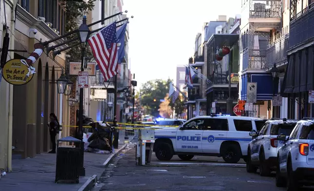 Emergency service vehicles form a security barrier to keep other vehicles out of the French Quarter after a vehicle drove into a crowd on New Orleans' Canal and Bourbon Street, Wednesday Jan. 1, 2025. (AP Photo/Gerald Herbert)