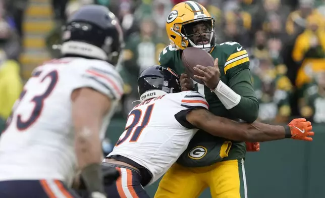 Chicago Bears safety Kevin Byard III, middle, forces Green Bay Packers quarterback Malik Willis to fumble the ball, which was recovered by the Bears, during the second half of an NFL football game, Sunday, Jan. 5, 2025, in Green Bay, Wis. (AP Photo/Morry Gash)