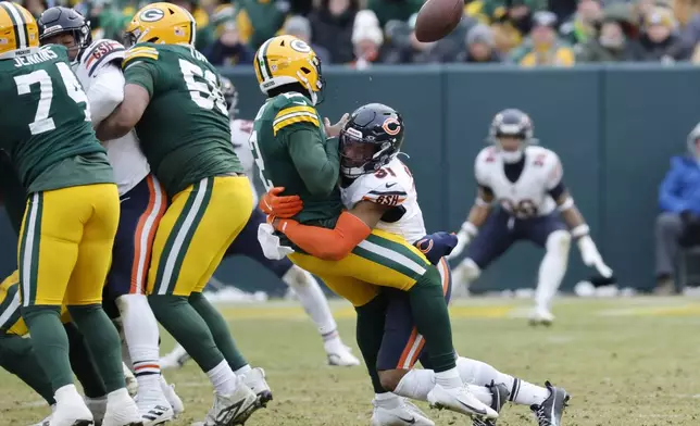 Chicago Bears safety Kevin Byard III (31) forces Green Bay Packers quarterback Malik Willis to fumble the ball, which was recovered by the Bears, during the second half of an NFL football game, Sunday, Jan. 5, 2025, in Green Bay, Wis. (AP Photo/Mike Roemer)