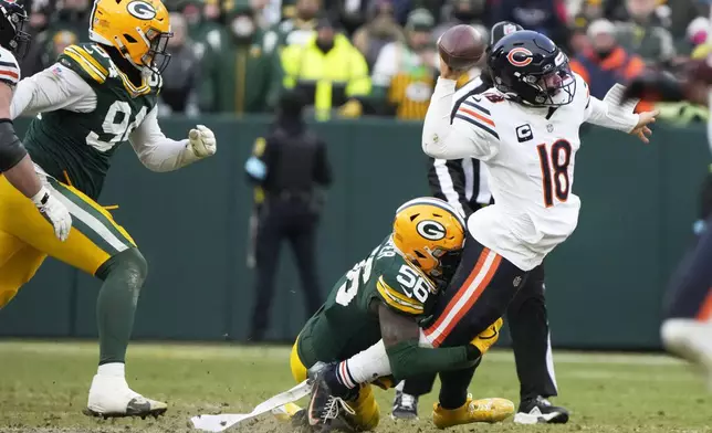 Chicago Bears' Caleb Williams throws as he is hit by Green Bay Packers' Edgerrin Cooper during the second half of an NFL football game Sunday, Jan. 5, 2025, in Green Bay, Wis. (AP Photo/Morry Gash)