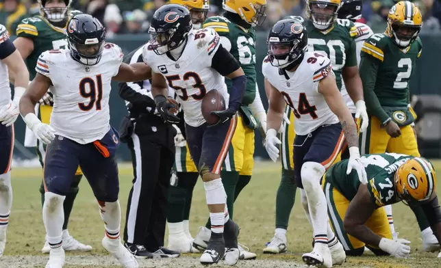 Chicago Bears linebacker T.J. Edwards (53) reacts after recovering a fumble by Green Bay Packers quarterback Malik Willis (2) with defensive tackle Chris Williams (91) and defensive end Austin Booker (94) during the second half of an NFL football game, Sunday, Jan. 5, 2025, in Green Bay, Wis. (AP Photo/Mike Roemer)