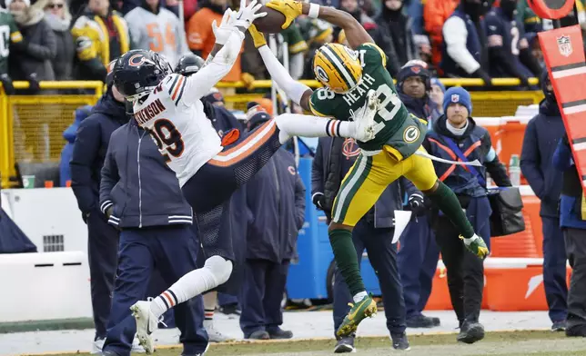 Green Bay Packers wide receiver Malik Heath (18) catches a pass against Chicago Bears cornerback Tyrique Stevenson (29) during the second half of an NFL football game, Sunday, Jan. 5, 2025, in Green Bay, Wis. (AP Photo/Mike Roemer)