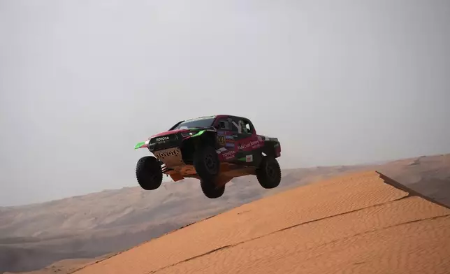 Driver Yazeed Al Rajhi and co-driver Timo Gottschalk compete during the sixth stage of the Dakar Rally between Hail and Al Duwadimi, Saudi Arabia, Saturday, Jan. 11, 2025. (AP Photo/Christophe Ena)