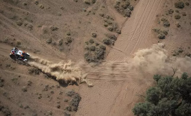 Driver Henk Lategan and co-driver Brett Cummings compete during the sixth stage of the Dakar Rally between Hail and Al Duwadimi, Saudi Arabia, Saturday, Jan. 11, 2025. (AP Photo/Christophe Ena)