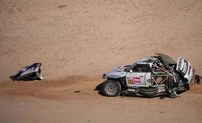 The car of Driver Guerlain Chicherit and co-driver Alex Winocq is pictured after they crashed during the sixth stage of the Dakar Rally between Hail and Al Duwadimi, Saudi Arabia, Saturday, Jan. 11, 2025. (AP Photo/Christophe Ena)