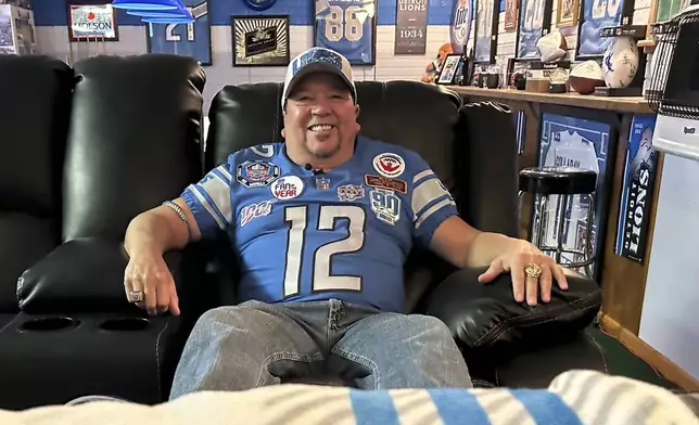 Detroit Lions fan Rob Gonzales sits in the chair he uses to watch Lions NFL football away games from the basement of his home Thursday, Jan. 16, 2025, in Frenchtown Township, Mich. (AP Photo/Mike Householder)