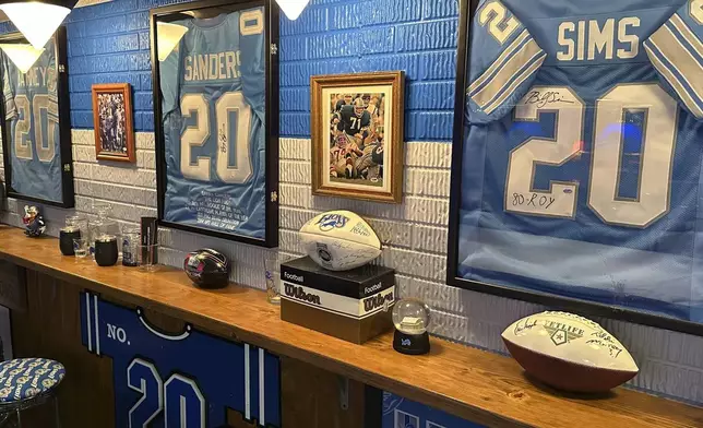 Signed jerseys of Detroit Lions NFL football greats Lem Barney, Barry Sanders and Billy Sims are displayed in fan Rob Gonzales' basement Thursday, Jan. 16, 2025, in Frenchtown Township, Mich. (AP Photo/Mike Householder)