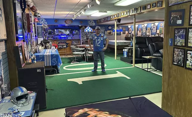 Detroit Lions NFL football fan Rob Gonzales stands on Pontiac Silverdome turf in the basement of his home Thursday, Jan. 16, 2025, in Frenchtown Township, Mich. (AP Photo/Mike Householder)