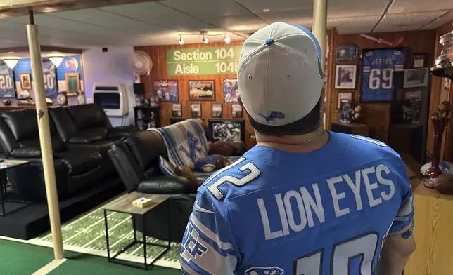 Detroit Lions NFL football fan Rob Gonzales looks up while standing in the basement of his home Thursday, Jan. 16, 2025, in Frenchtown Township, Mich. (AP Photo/Mike Householder)
