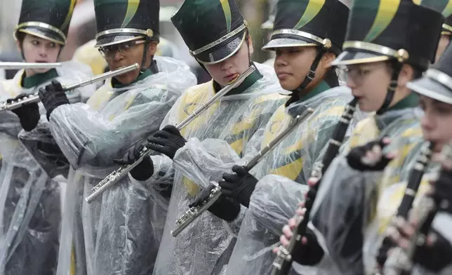 Rain falls as performers prepare to take part in the New Year's Day Parade in central London, Wednesday Jan. 1, 2025. (Jonathan Brady/PA via AP)