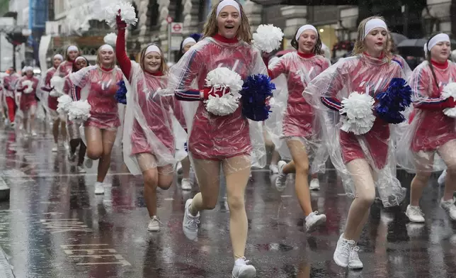 Rain falls as performers take part in the New Year's Day Parade in central London, Wednesday Jan. 1, 2025. (Jonathan Brady/PA via AP)