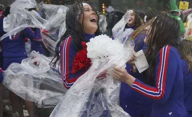 Rain falls as performers prepare to take part in the New Year's Day Parade in central London, Wednesday Jan. 1, 2025. (Jonathan Brady/PA via AP)