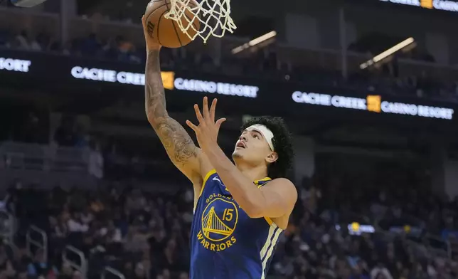 Golden State Warriors forward Gui Santos (15) shoots against against the Utah Jazz during the first half of an NBA basketball game in San Francisco, Tuesday, Jan. 28, 2025. (AP Photo/Jeff Chiu)