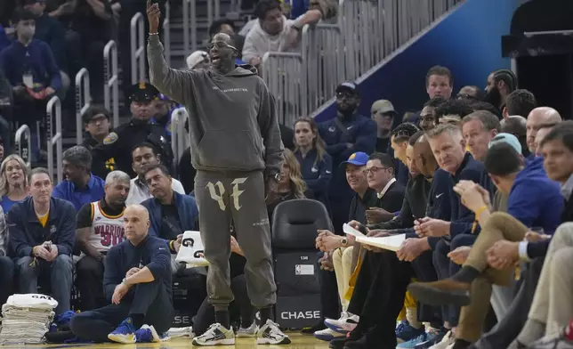 Golden State Warriors forward Draymond Green, standing, gestures toward teammates during the first half of an NBA basketball game against the Utah Jazz in San Francisco, Tuesday, Jan. 28, 2025. (AP Photo/Jeff Chiu)