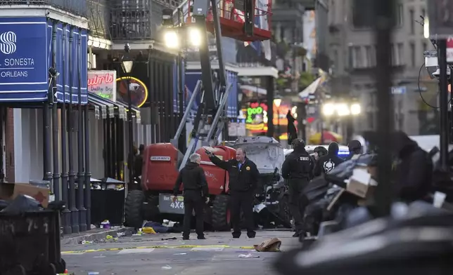 EDS NOTE: GRAPHIC CONTENT - Emergency personnel work the scene on Bourbon Street after a vehicle drove into a crowd on New Orleans' Canal and Bourbon Street, Wednesday Jan. 1, 2025. (AP Photo/Gerald Herbert)