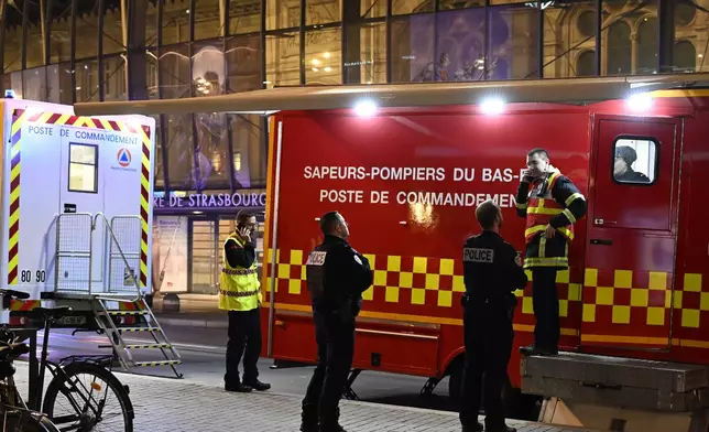 Police officers and rescue workers gather at the train station after two trams collided, injuring dozens of people, though none critically, firefighters said, Saturday, Jan. 11, 2025 in Strasbourg, eastern France. (AP Photo/Pascal Bastien)