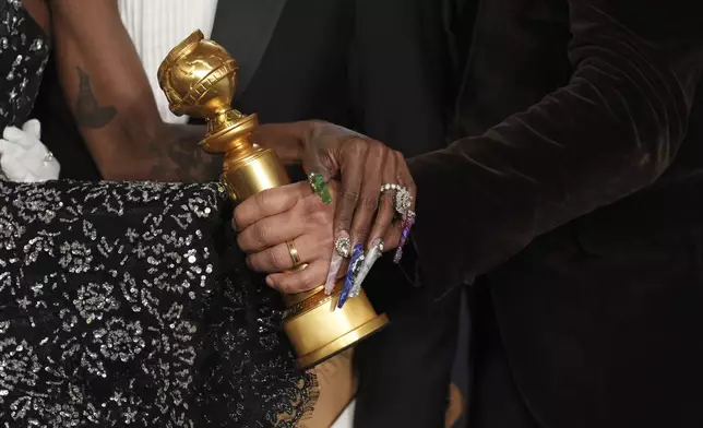 Cynthia Erivo, left, and Jon M. Chu pose with the award for cinematic and box office achievement for "Wicked" in the press room during the 82nd Golden Globes on Sunday, Jan. 5, 2025, at the Beverly Hilton in Beverly Hills, Calif. (AP Photo/Chris Pizzello)