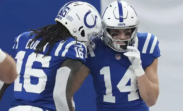 Indianapolis Colts wide receiver Alec Pierce (14) reacts with Indianapolis Colts wide receiver Ashton Dulin (16) after Pierce scored a touchdown during the first half of an NFL football game, Sunday, Jan. 5, 2025, in Indianapolis. (AP Photo/Darron Cummings)