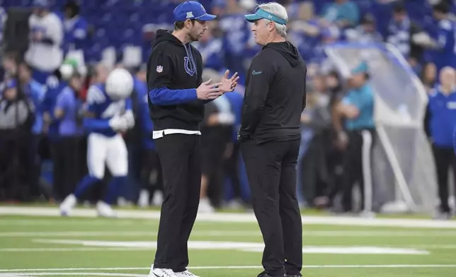 Indianapolis Colts head coach Shane Steichen, left, and Jacksonville Jaguars head coach Doug Pederson talk on the field before an NFL football game, Sunday, Jan. 5, 2025, in Indianapolis. (AP Photo/Michael Conroy)