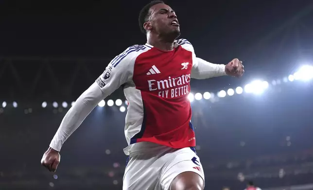 Arsenal's Gabriel celebrates after Tottenham's Dominic Solanke scored an own goal during the English Premier League soccer match between Arsenal and Tottenham Hotspur at the Emirates Stadium, London, Wednesday, Jan. 15, 2025. (Bradley Collyer/PA via AP)