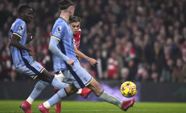 Arsenal's Leandro Trossard, centre, scores his side's second goal during the English Premier League soccer match between Arsenal and Tottenham Hotspur at the Emirates Stadium, London, Wednesday, Jan. 15, 2025. (Bradley Collyer/PA via AP)