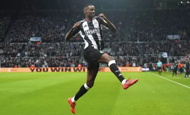 Newcastle United's Alexander Isak celebrates after scoring the opening goal during the English Premier League soccer match between Newcastle United and Wolverhampton Wanderers at St. James' Park, Newcastle, England, Wednesday, Jan. 15, 2025. (Owen Humphreys/PA via AP)