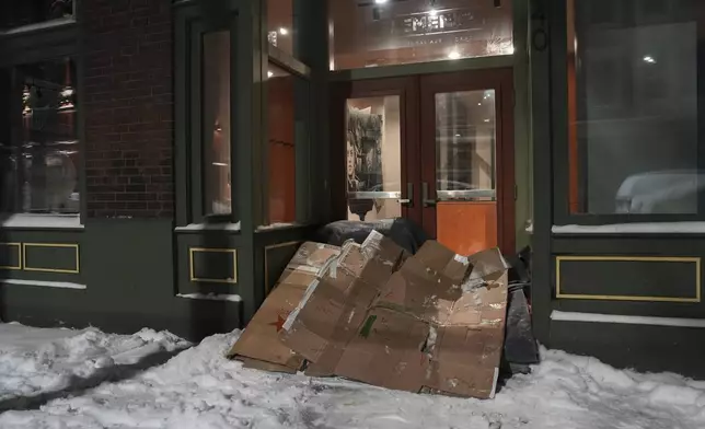 A makeshift shelter sits at the entrance to a building, Tuesday, Jan. 7, 2025, in Cincinnati. (AP Photo/Joshua A. Bickel)