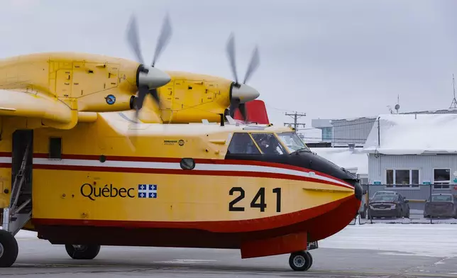 A SOPFEU CL-415 is taxiing for takeoff to help in the California wildfires at the Quebec City airport, Wednesday, Jan. 15, 2025. (Francis Vachon/The Canadian Press via AP)