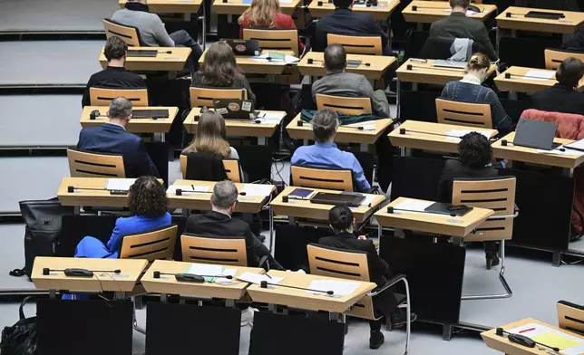 Members of parliament from the Green partiy turn their backs to the speaker during a speech by Berlin AfD MP Martin Trefzer, member of the Berlin House of Representatives, during the 60th plenary session of the Berlin House of Representatives, in Berlin, Thursday, Jan. 30, 2024. (Sebastian Christoph Gollnow/dpa via AP)