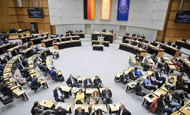 Members of parliament from the SPD, Green and Left parties turn their backs to the speaker during a speech by Martin Trefzer (AfD), member of the Berlin House of Representatives, during the 60th plenary session of the Berlin House of Representatives, in Berlin, Thursday, Jan. 30, 2024. (Sebastian Christoph Gollnow/dpa via AP)