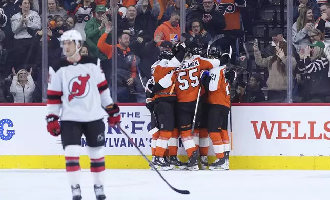 Philadelphia Flyers' players celebrate after a goal by Joel Farabee during the first period of an NHL hockey game against the New Jersey Devils, Monday, Jan. 27, 2025, in Philadelphia. (AP Photo/Matt Slocum)
