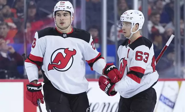 New Jersey Devils' Timo Meier, left, and Jesper Bratt celebrate after Meier's goal during the third period of an NHL hockey game against the Philadelphia Flyers, Monday, Jan. 27, 2025, in Philadelphia. (AP Photo/Matt Slocum)