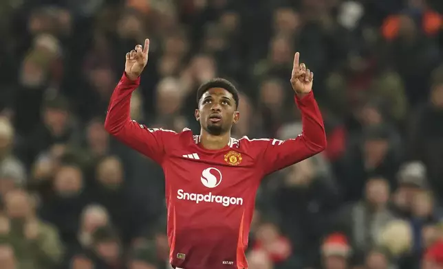 Manchester United's Amad Diallo celebrates after scoring his side's first goal during the English Premier League soccer match between Manchester United and Southampton at the Old Trafford stadium in Manchester, England, Thursday, Jan. 16, 2025. (AP Photo/Dave Thompson)