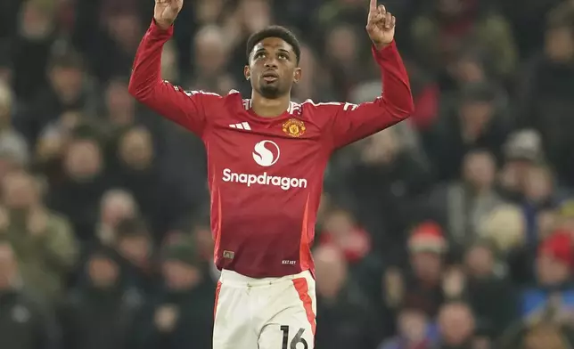 Manchester United's Amad Diallo celebrates after scoring his side's first goal during the English Premier League soccer match between Manchester United and Southampton at the Old Trafford stadium in Manchester, England, Thursday, Jan. 16, 2025. (AP Photo/Dave Thompson)