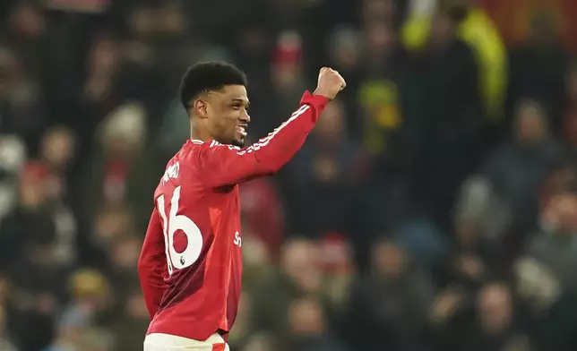 Manchester United's Amad Diallo celebrates after scoring his side's third goal during the English Premier League soccer match between Manchester United and Southampton at the Old Trafford stadium in Manchester, England, Thursday, Jan. 16, 2025. (AP Photo/Dave Thompson)