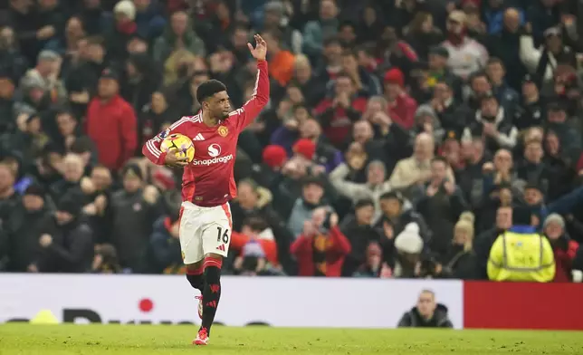Manchester United's Amad Diallo celebrates after scoring his side's first goal during the English Premier League soccer match between Manchester United and Southampton at the Old Trafford stadium in Manchester, England, Thursday, Jan. 16, 2025. (AP Photo/Dave Thompson)