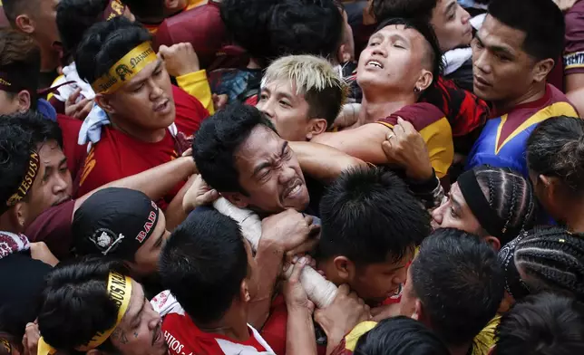 Devotees grab the rope as they pull a glass-covered carriage carrying the image of Jesus Nazareno during its annual procession in Manila, Philippines, Thursday, Jan. 9, 2025. (AP Photo/Basilio Sepe)