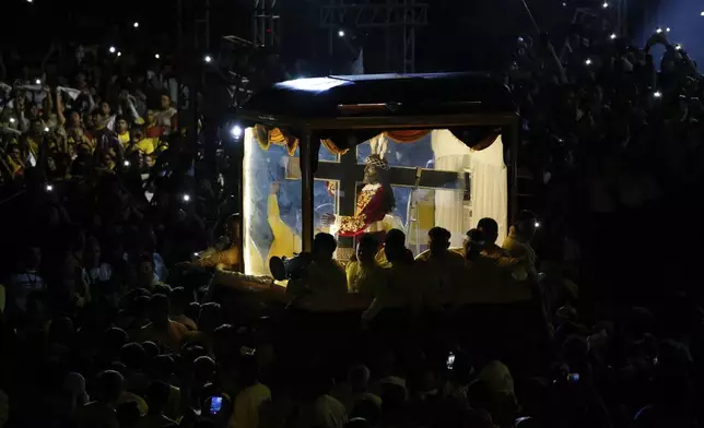 Devotees pull a glass-covered carriage carrying the image of Jesus Nazareno during its annual procession in Manila, Philippines, Thursday. Jan. 9, 2025. (AP Photo/Basilio Sepe)