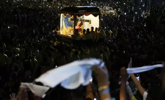 Devotees pull a glass-covered carriage carrying the image of Jesus Nazareno during its annual procession in Manila, Philippines, Thursday. Jan. 9, 2025. (AP Photo/Basilio Sepe)