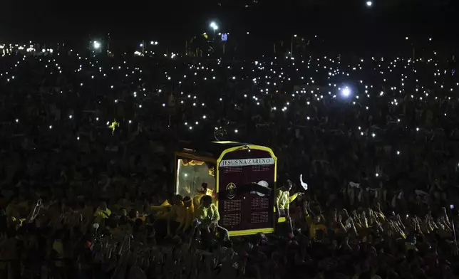 Devotees pull a glass-covered carriage carrying the image of Jesus Nazareno during its annual procession in Manila, Philippines, Thursday. Jan. 9, 2025. (AP Photo/Basilio Sepe)