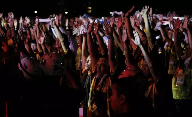 Devotees raise their hands as they join the annual procession of Jesus Nazareno in Manila, Philippines, Thursday. Jan. 9, 2025. (AP Photo/Basilio Sepe)