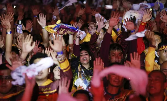 Devotees raise their hands as they join the annual procession of Jesus Nazareno in Manila, Philippines, Thursday. Jan. 9, 2025. (AP Photo/Basilio Sepe)