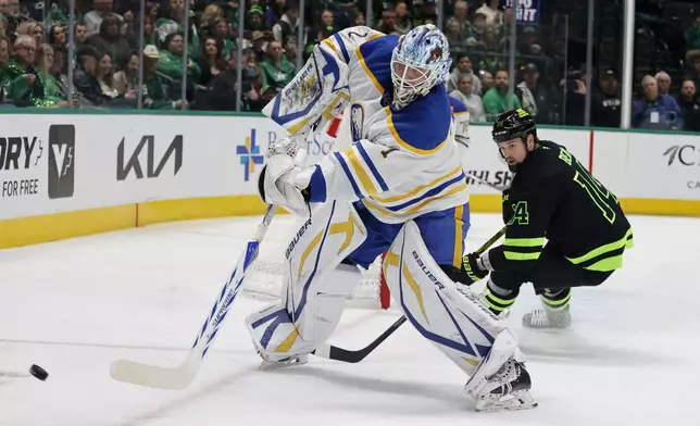 Buffalo Sabres goaltender Ukko-Pekka Luukkonen (1) diverts the puck in front of Dallas Stars left wing Jamie Benn (14) during the first period of an NHL hockey game in Dallas, Tuesday, Dec. 31, 2024. (AP Photo/Michael Ainsworth)